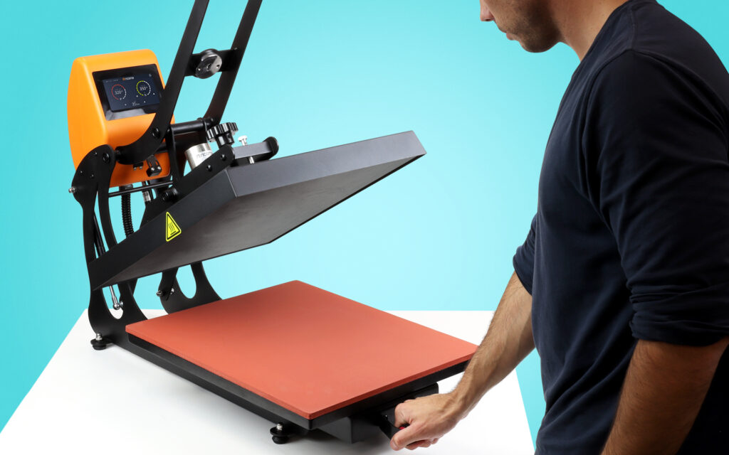 man with heat press pulling out the platen