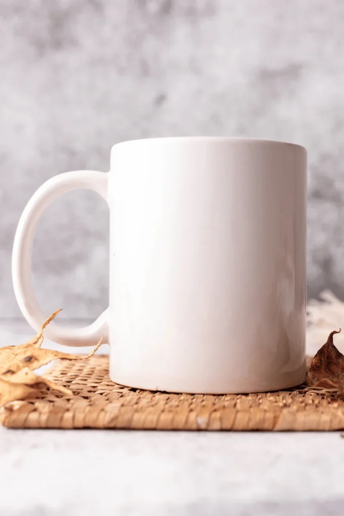 how to make custom mugs to sell image of a white mug sitting on a table with a gray background