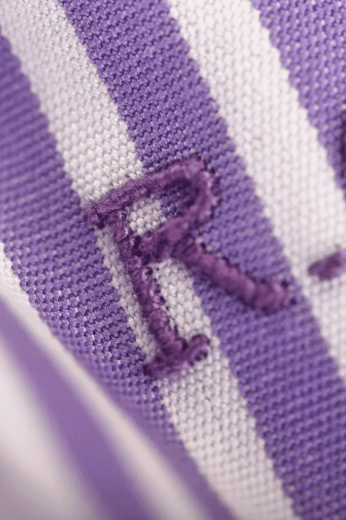 embroidered striped fabric with letter R
