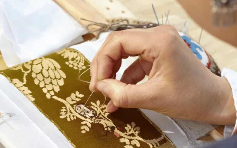 woman hand embroidering pattern