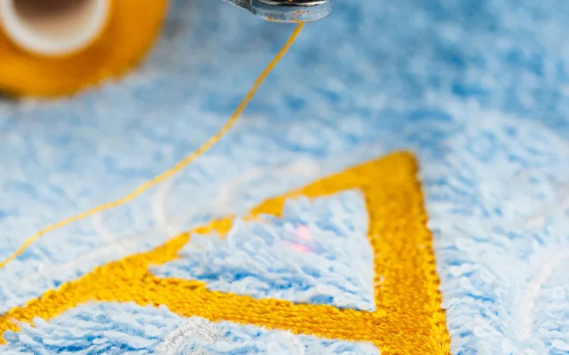 Blue towel in hoop of Embroidery Machine