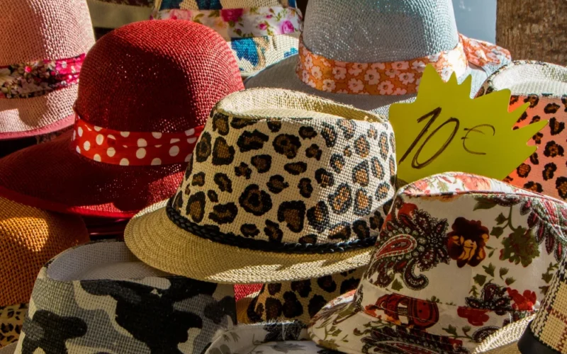Colorful collection of hats on display at a market