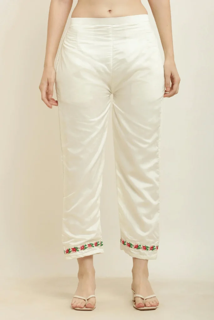 image of white pants with embroidery on bottom